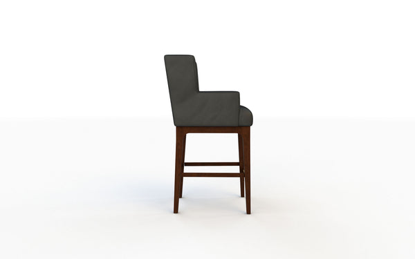 Bar stool with dark cushioned seat and wooden legs on a white background